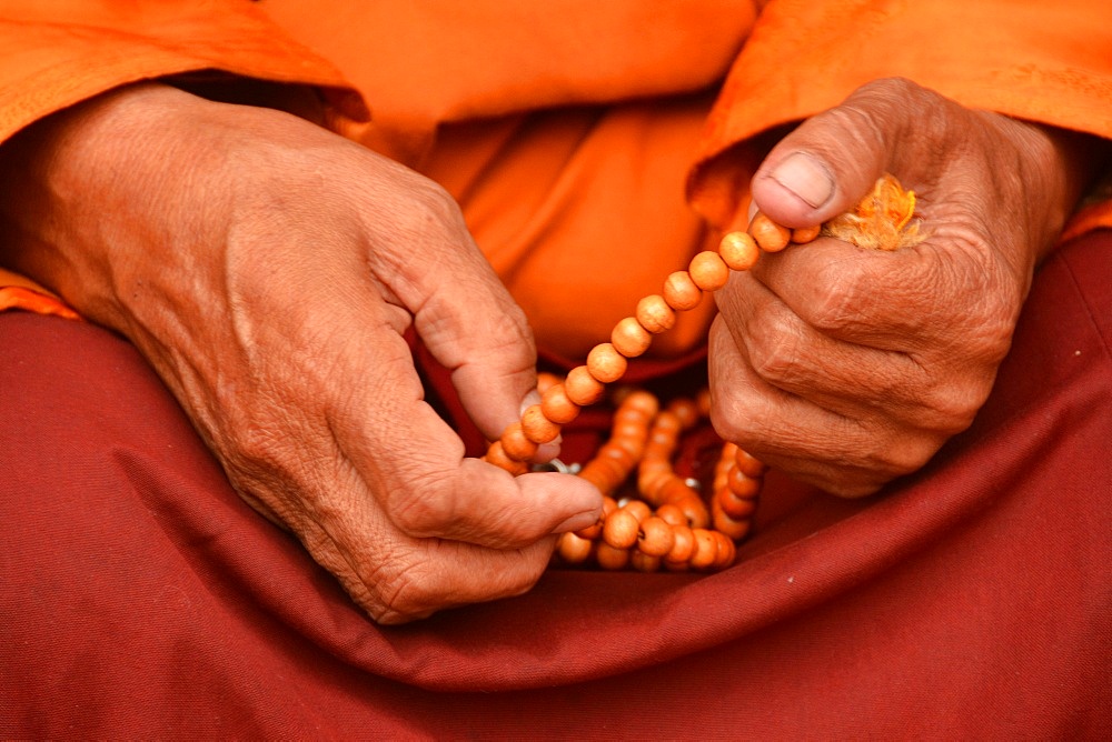 Tibetan monk holding prayer beads, Nepal, Asia