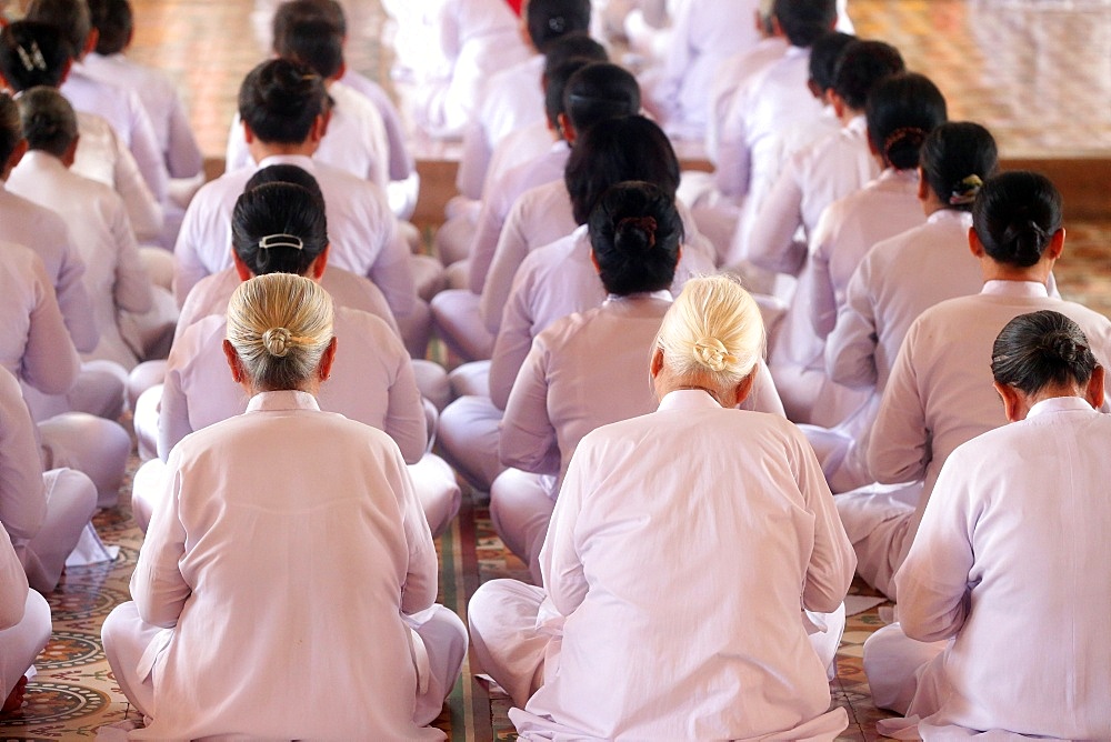 Praying devout women, ceremonial midday prayer, Cao Dai Holy See Temple, Tay Ninh, Vietnam, Indochina, Southeast Asia, Asia