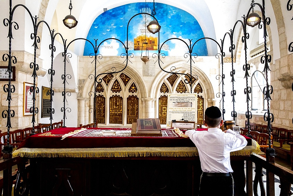 Boy reading at the teva, the four Sephardic Synagogues, Jerusalem old city, Israel, Middle East