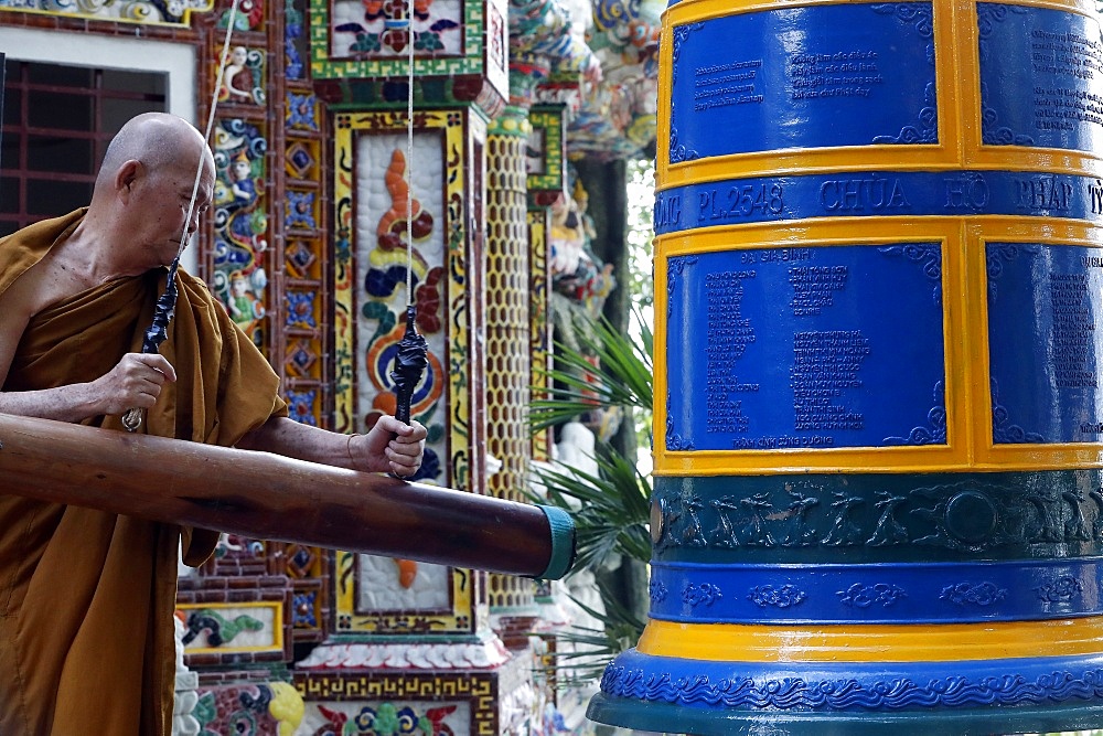 Ho Phap Buddhist temple, monk ringing bell in monastery, Vung Tau, Vietnam, Indochina, Southeast Asia, Asia