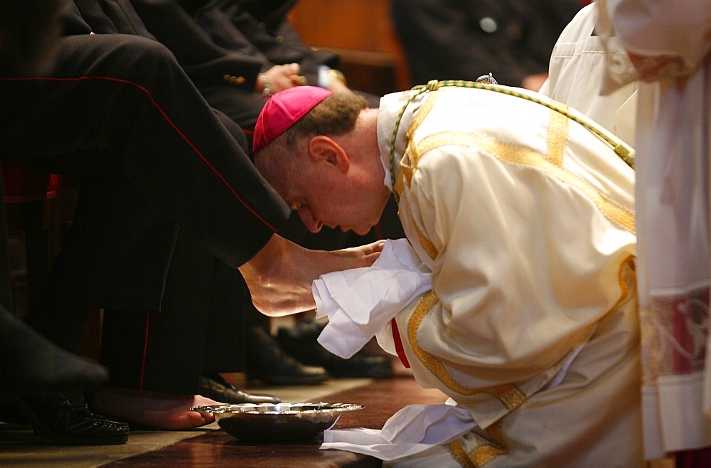 Bishop kissing feet after washing them, Easter Thursday Mass in St. Peter's Basilica, Vatican, Rome, Lazio, Italy, Europe