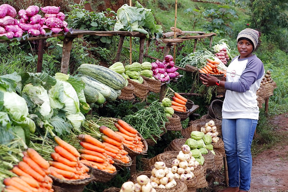 Woman selling fresh vegetables at market, Madagascar, Africa