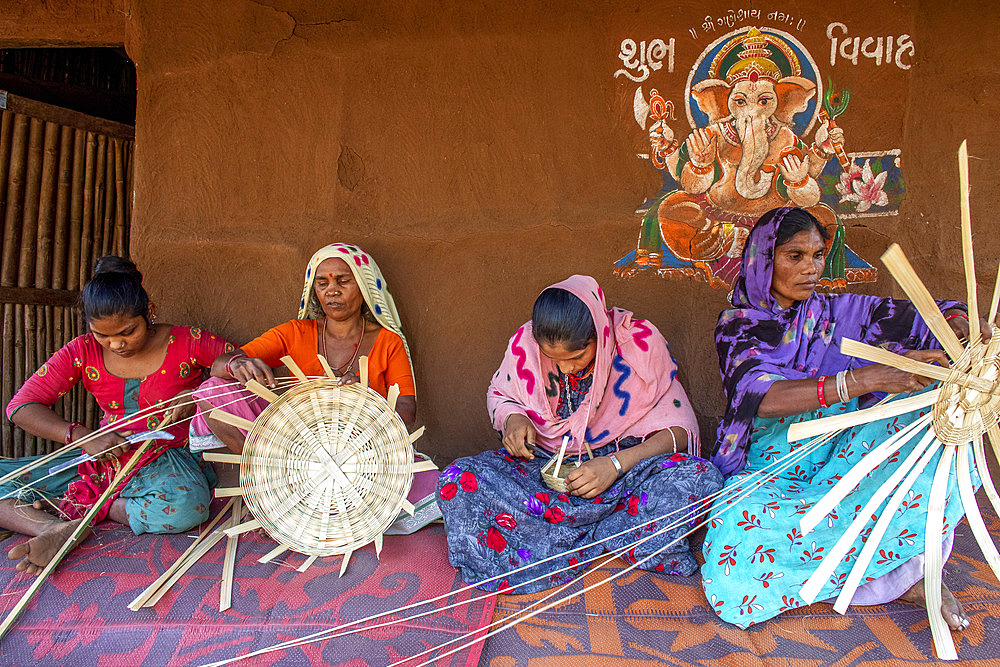 Adivasi women making baskets in a village in Narmada district, Gujarat, India, Asia