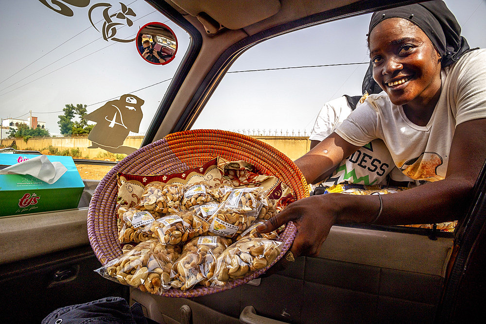 Girl selling cashew nuts in Thies, Senegal, West Africa, Africa