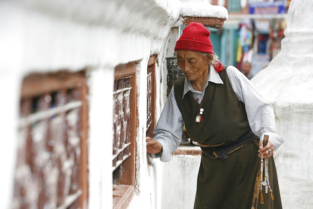 Woman and prayer wheels, Bodhnath Stupa, UNESCO World Heritage Site, Kathmandu, Nepal, Asia