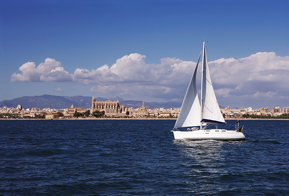 Yacht in the Bay of Palma looking back to La Seu Cathedral, Mallorca, Balearic Islands, Spain, Mediterranean, Europe