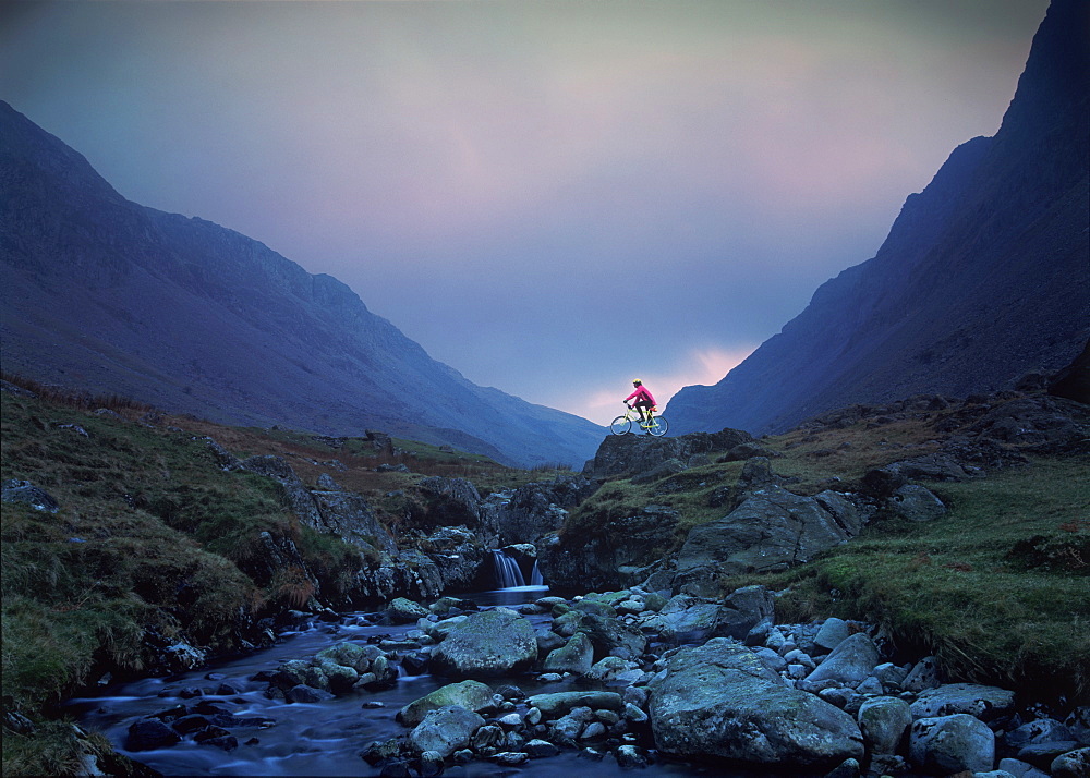 Cyclist on mountain bike, Honister Pass, The Lake District, Cumbria, England, United Kingdom, Europe