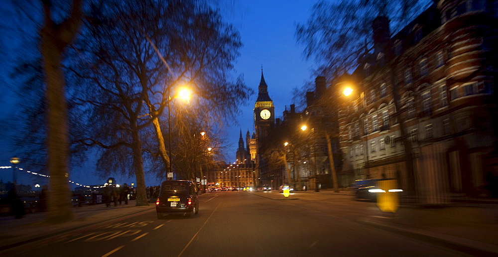 Taxi at dusk on The Embankment approaching The Houses of Parliament with Big Ben in distance, London, England, United Kingdom, Europe