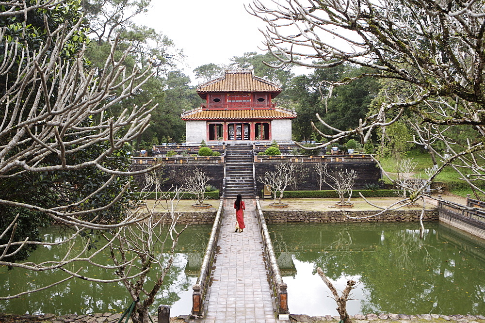 Schoolgirl walking through temple garden, Vietnam, Indochina, Southeast Asia, Asia