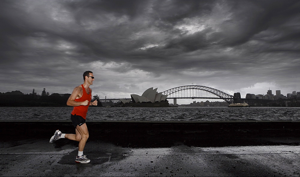 Man jogging in front of Sydney harbour, Sydney, New South Wales, Australia, Pacific