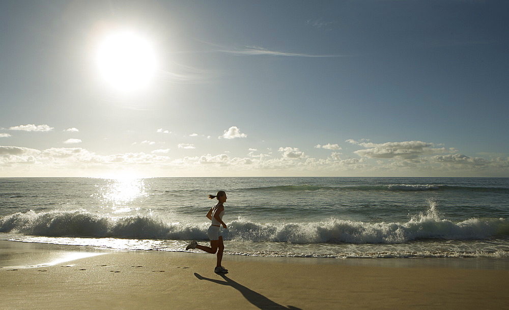 Early morning female runner, Bondi beach, Sydney, New South Wales, Australia, Pacific