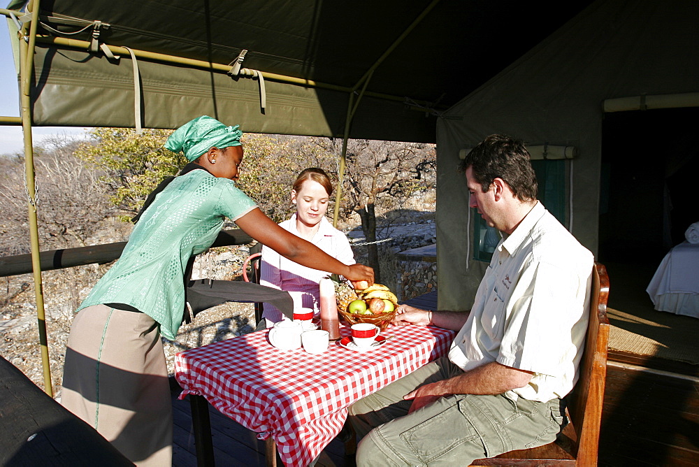 Breakfast on the terrace of a tent in Eagle Tented Camp, close to Etosha and Damaraland, Namibia, Africa