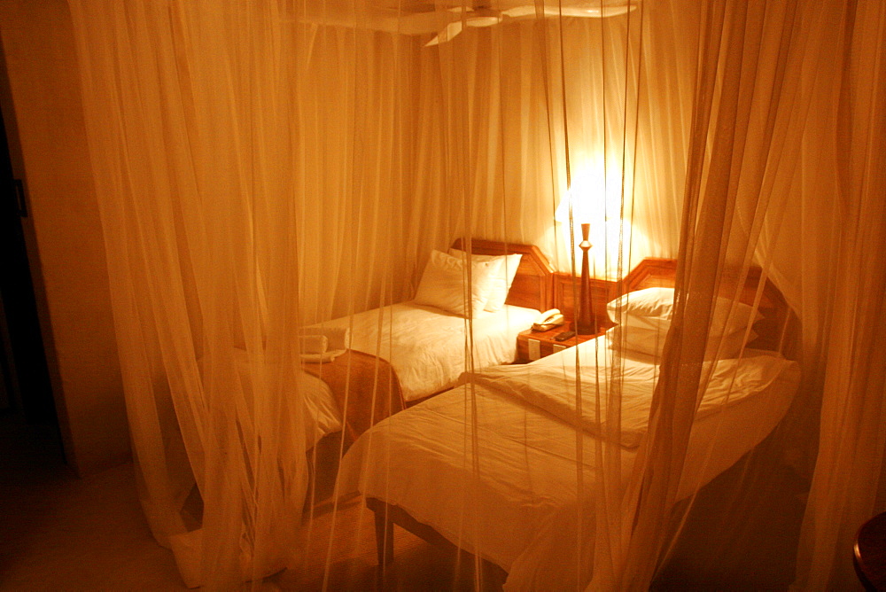 Under the mosquito nets, a room of the Mokuti Lodge, close to Etosha, Namibia, Africa