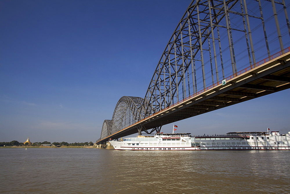 The Road to Mandalay cruise boat passing under the Mandalay bridge, Myanmar (Burma), Asia