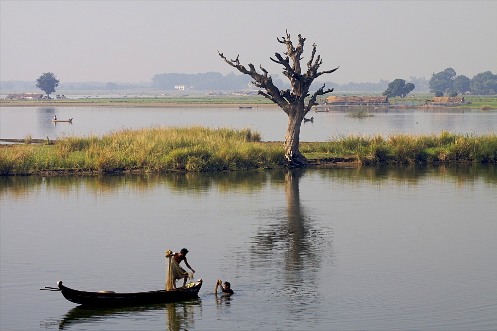 Fishermen on the U Bein lake seen from the teak bridge in Mandalay, Myanmar (Burma), Asia