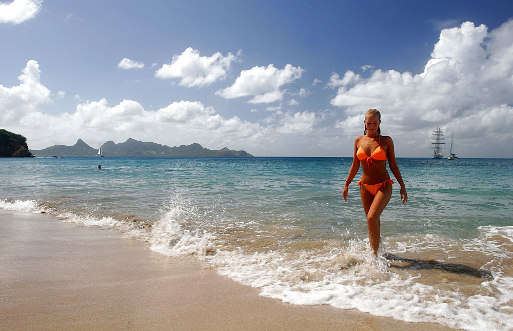 Tourist on the west coast of Mayreau with Union island in the background, The Grenadines, Windward Islands, West Indies, Caribbean, Central America