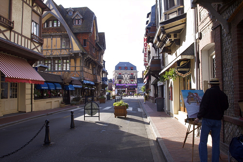 Some small shops and a painter in the town of Etretat, Seine Maritime, Normandy, France, Europe