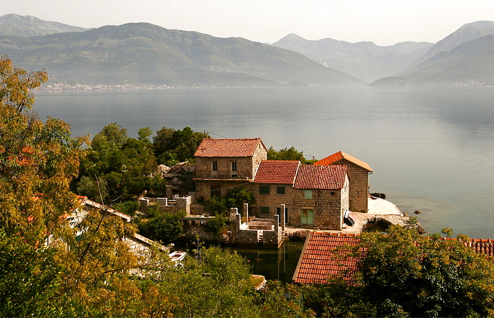 Typical houses with tiled roofs and stone walls on the Gulf of Kotor, Montenegro, Europe