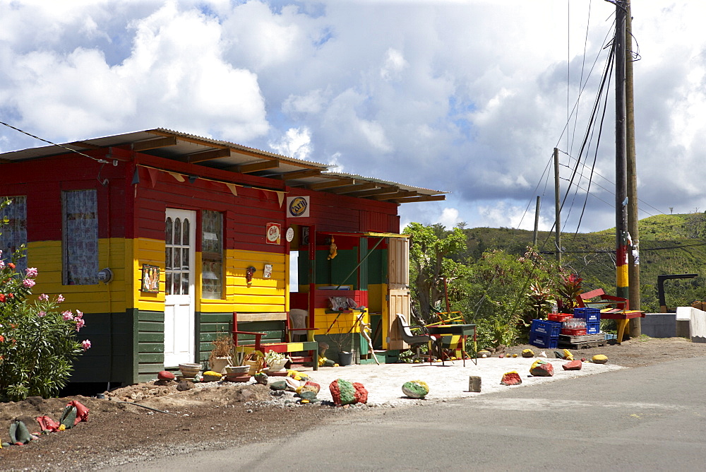 Roadside wooden building painted red, yellow and green, Grenada, Windward Islands, West Indies, Caribbean, Central America