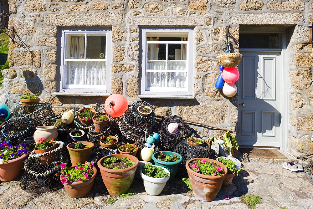 Crab pots outside a traditional fishing cottage at Penberth, Cornwall, England, United Kingdom, Europe