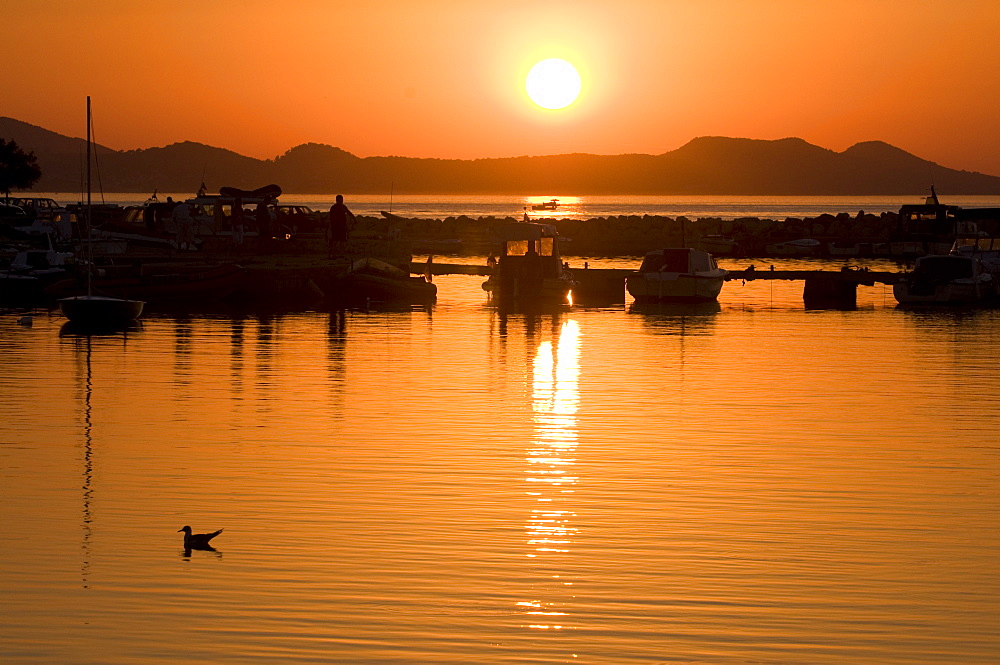 Sunset with boats in the foreground near Zardar, Croatia, Europe