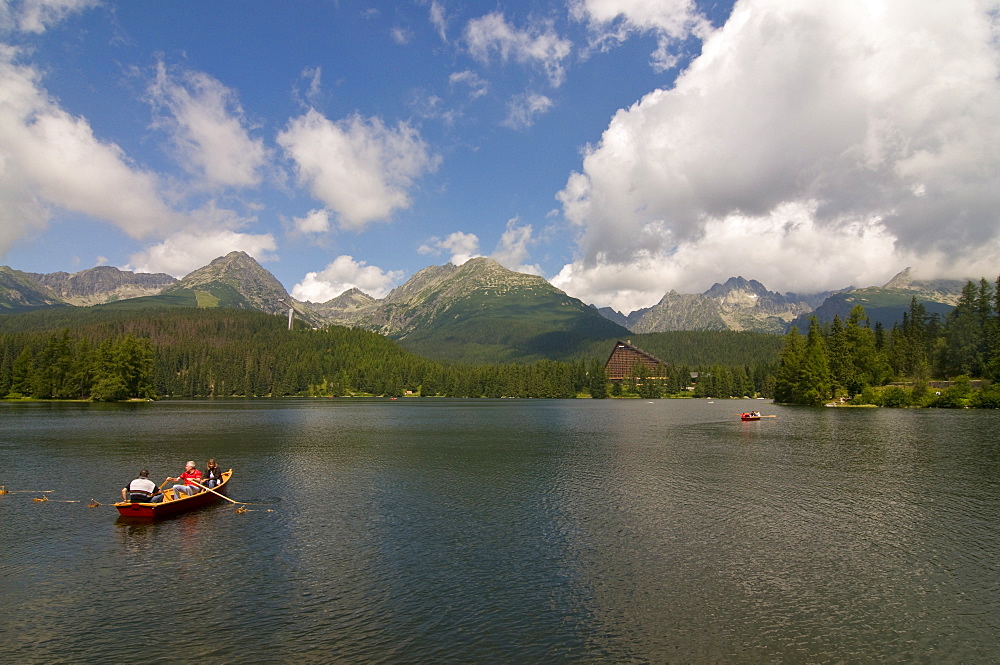 Tourists in a canoe at the Glacier lake of Strebske Pleso in the High Tatra, Slovakia, Europe