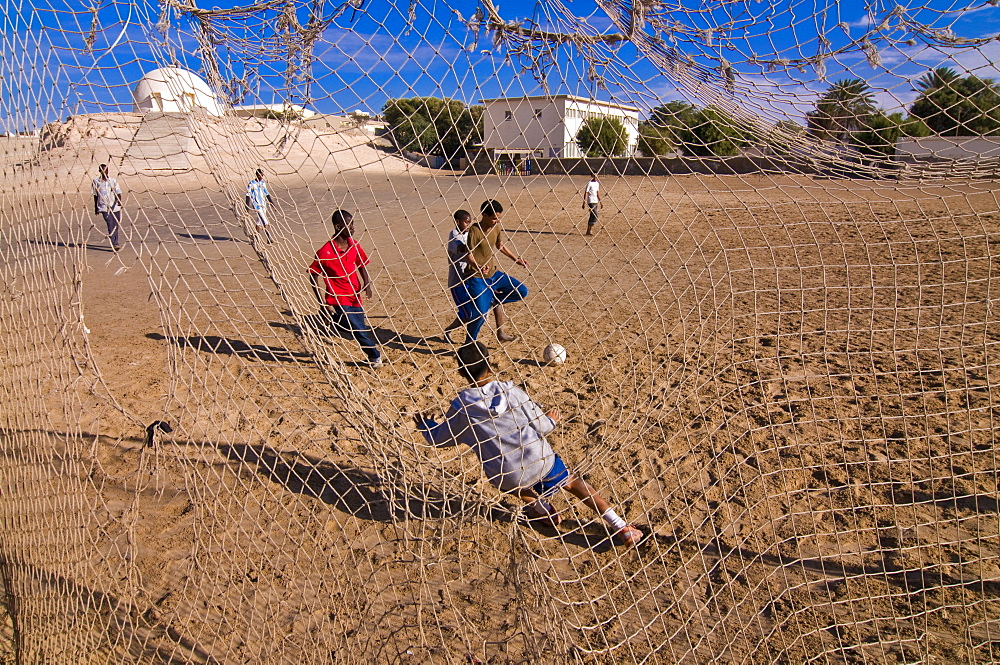 Children playing soccer at a sandy field, Nouadhibou, Mauritania, Africa