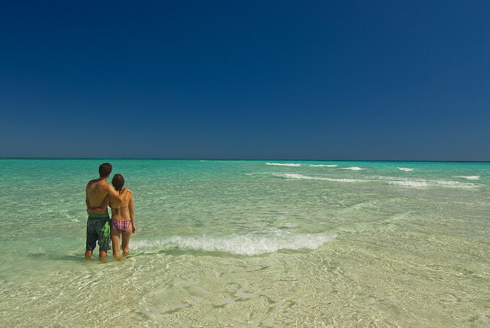 Happy couple on their honeymoon at the beautiful beach of Nosy Iranja near Nosy Be, Madagascar, Indian Ocean, Africa