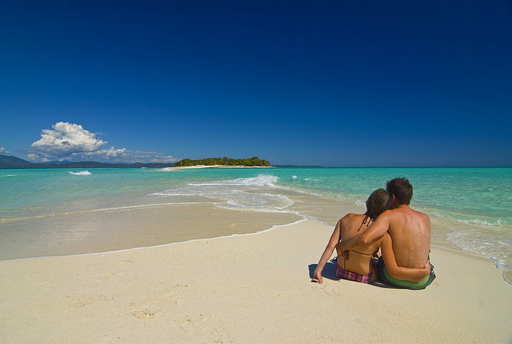 Happy couple on their honeymoon at the beautiful beach of Nosy Iranja near Nosy Be, Madagascar, Indian Ocean, Africa