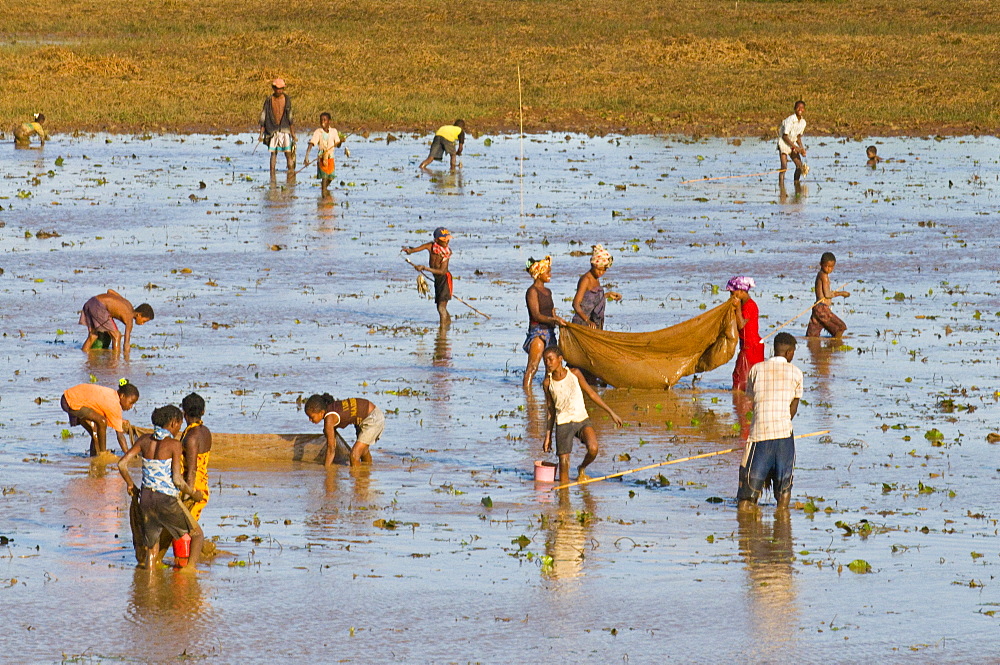 People fishing in a shallow lake near Diego Suarez (Antsiranana), Madagascar, Africa