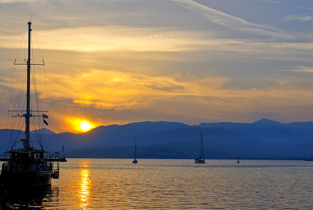 Sailing boat at sunset in the harbor of Nafplio, Peloponnese, Greece, Europe