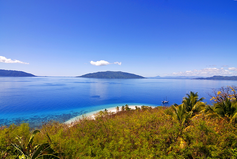 Crystal clear water and white sand beach, in the background Nosy Komab, Nosy Be, Madagascar, Indian Ocean, Africa