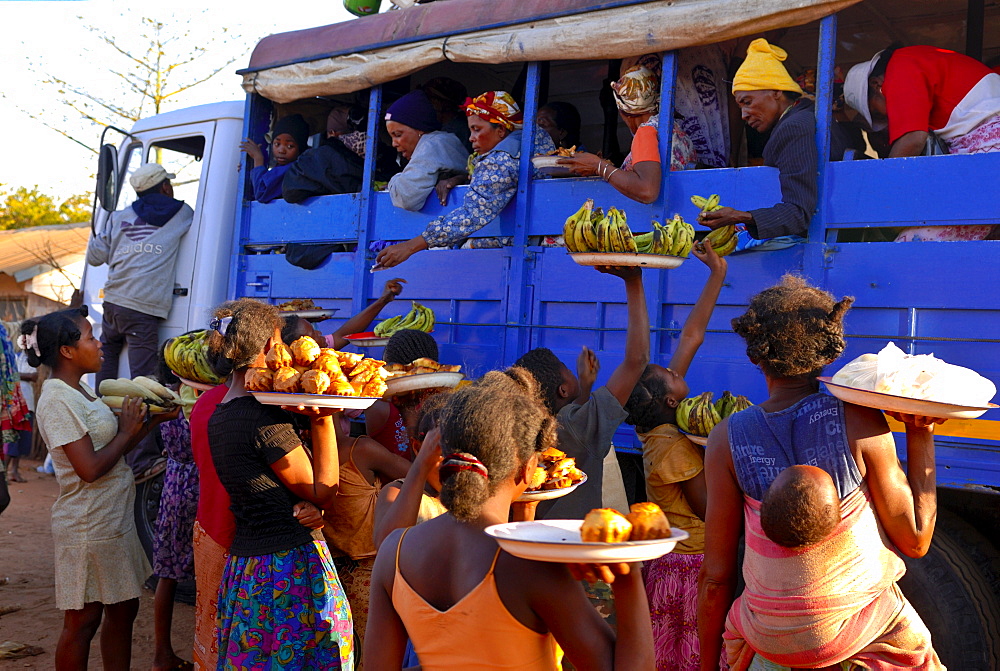 Women selling fruit to people in a local bus, Toliara, Madagascar, Africa