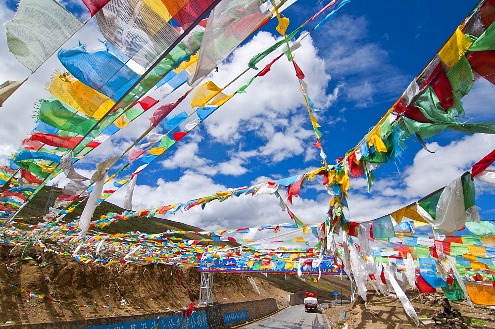 Prayer flags crossing the Friendship Highway between Lhasa and Kathmandu, Tibet, China, Asia