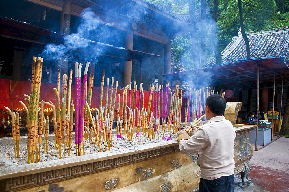 Burning sticks of Tibetan incense in a monastery above the giant Buddha of Leshan, Sichuan, China, Asia