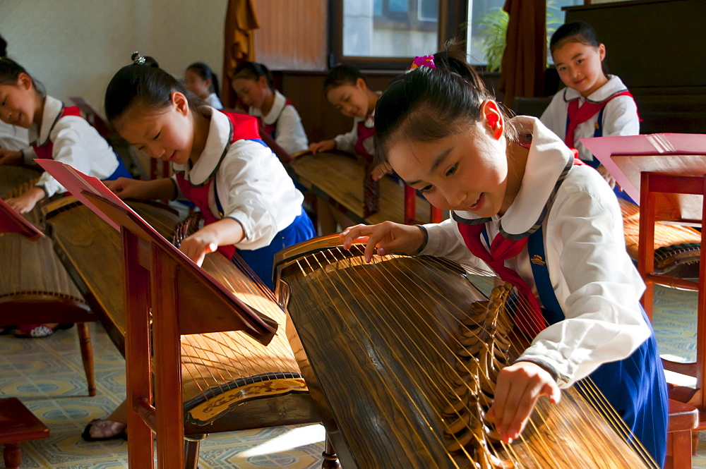 Young girls playing traditional instruments in the Schoolchildrens palace, Pyongyang, North Korea, Asia