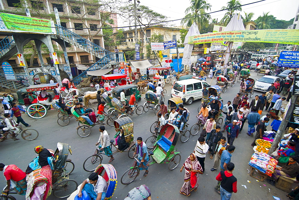 Busy rickshaw traffic on a street crossing in Dhaka, Bangladesh, Asia