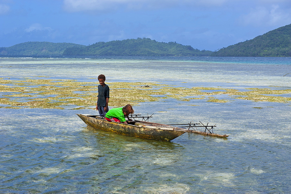 Young boys fishing near Samarai, the old capital, Papua New Guinea, Pacific