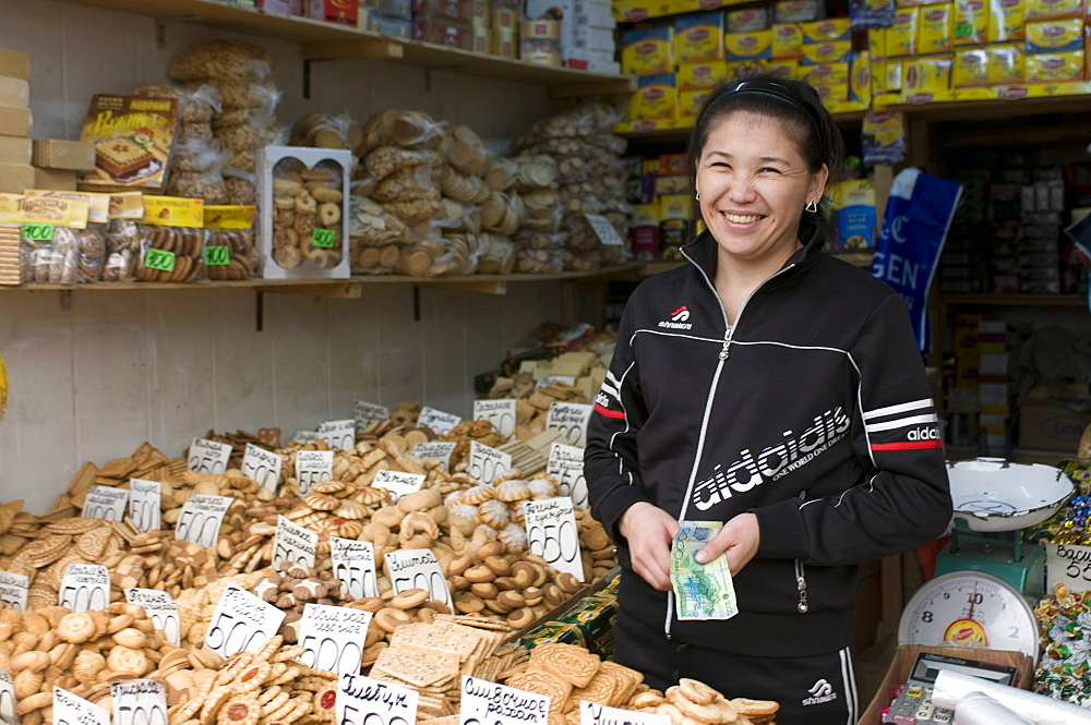 Friendly woman selling biscuits at a market stand, Alma Ata, Kazakhstan, Central Asia, Asia