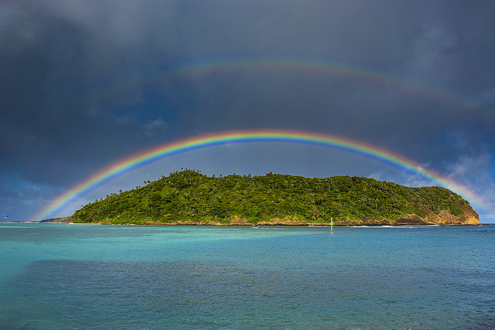 Incredible rainbow over an islet off Ofu Island, Manua Island group, American Samoa, South Pacific, Pacific