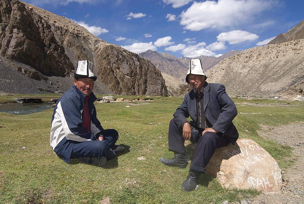 Smiling men with traditional Kyrgyz hats, Madyian, Tajikistan, Central Asia, Asia