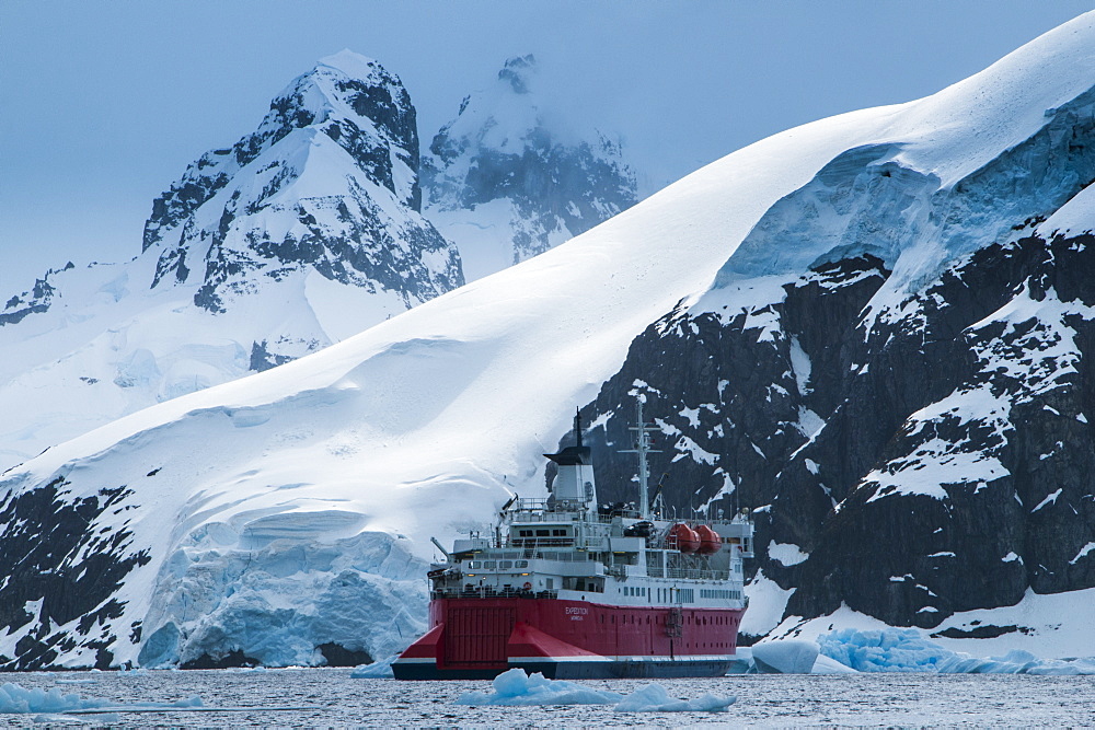 Cruise ship in front of the glaciers and icefields of Danco Island, Antarctica, Polar Regions