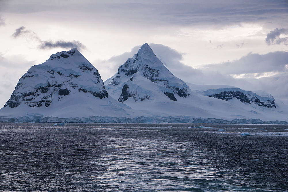 Dark clouds over the mountains and glaciers of Port Lockroy research station, Antarctica, Polar Regions