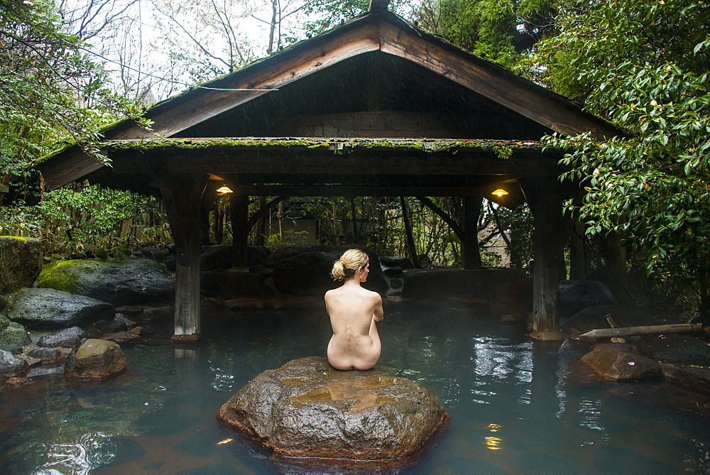 Woman enjoying the hot waters of the Kurokawa onsen, public spa, Kyushu, Japan, Asia