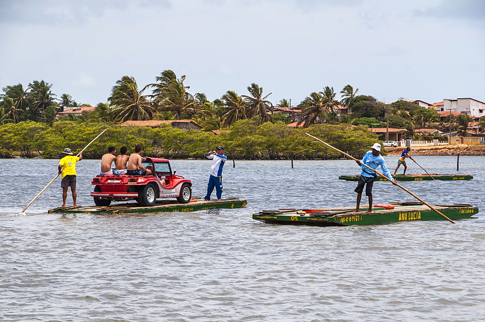 People with sand buggies crossing a river north of Natal, Rio Grande do Norte, Brazil, South America