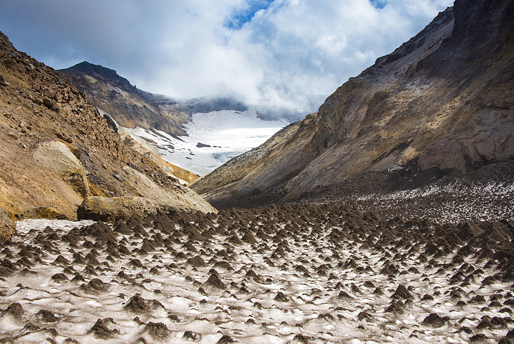 Little sand mounds on a glacier field on Mutnovsky volcano, Kamchatka, Russia, Eurasia 