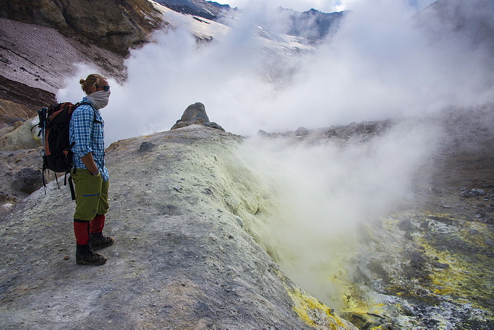 Tourists standing by smoking fumaroles on Mutnovsky volcano, Kamchatka, Russia, Eurasia 