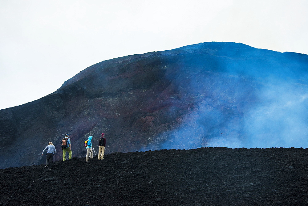 Tourists looking at an active lava eruption on the Tolbachik volcano, Kamchatka, Russia, Eurasia 