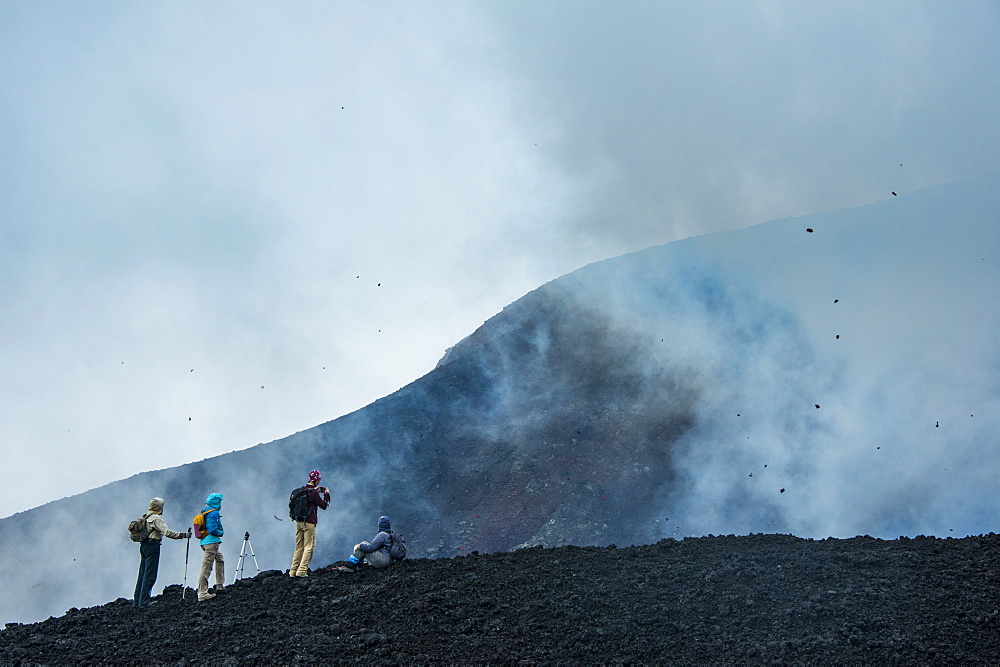 Tourists looking at an active lava eruption on the Tolbachik volcano, Kamchatka, Russia, Eurasia 