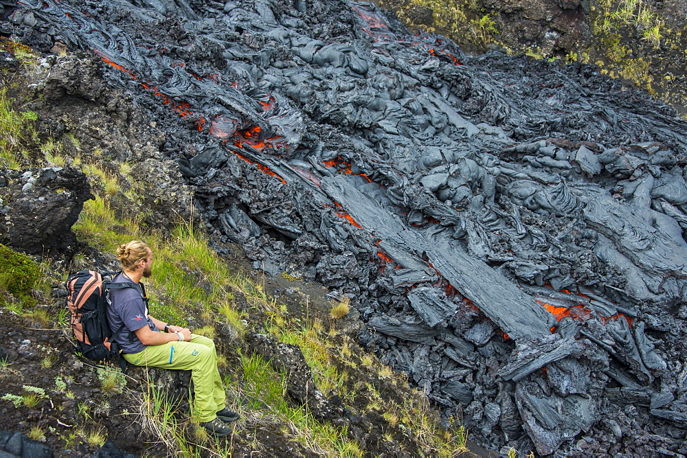 Man watching an active lava stream, Tolbachik volcano, Kamchatka, Russia, Eurasia